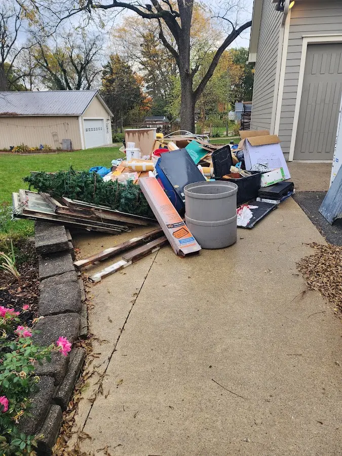 Dumpster being loaded with debris for 10 Yard Dumpster Rental in Mission Bend